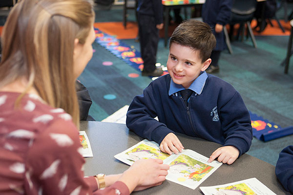 Our Lady of Mount Carmel Catholic Primary School Mt Pritchard Bonnyrigg - student reading a book with teacher